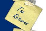 Photograph of a postit note with Tax Returns written on it.