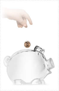 Photograph of money being put in a glass piggy bank.
